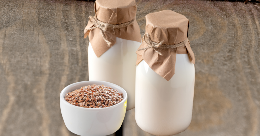 bottles of kefir and bowl of flaxseeds on table